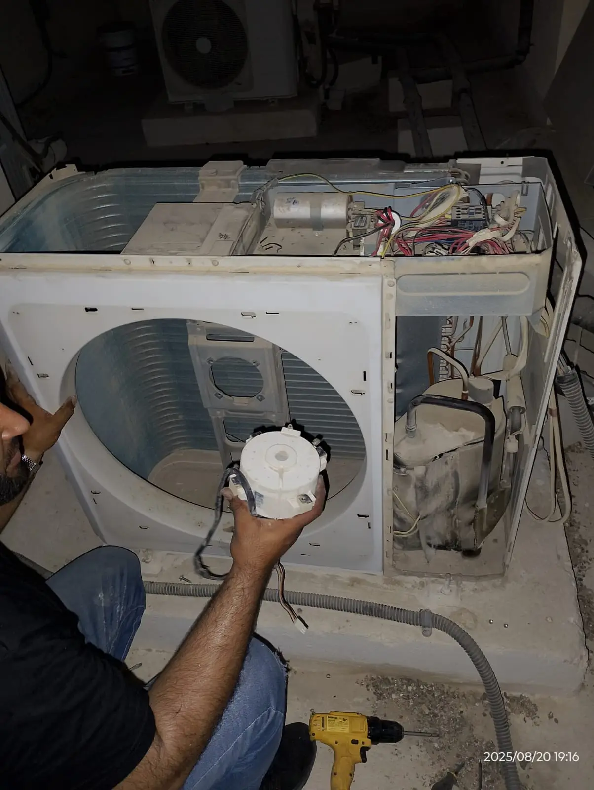Technicians repairing a wall-mounted AC unit in a Dubai property — supporting project view 3