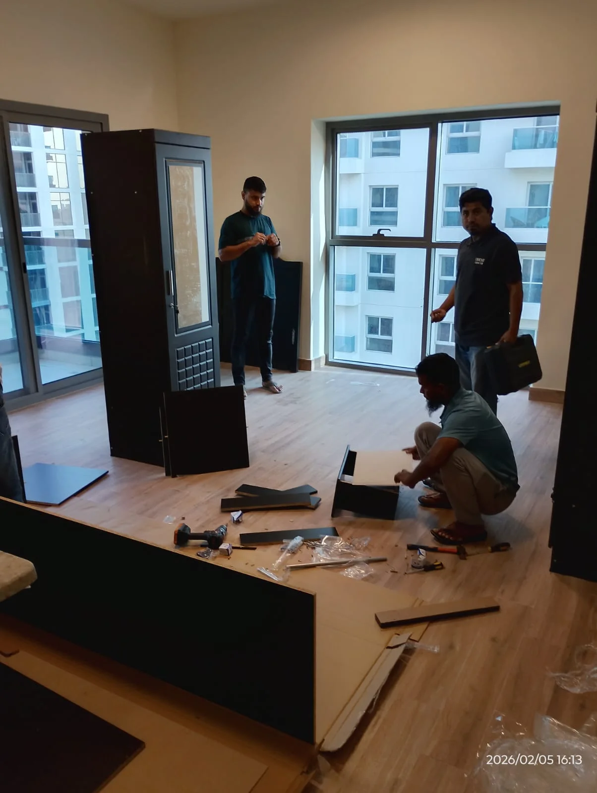Technicians assembling a wardrobe inside a Dubai home