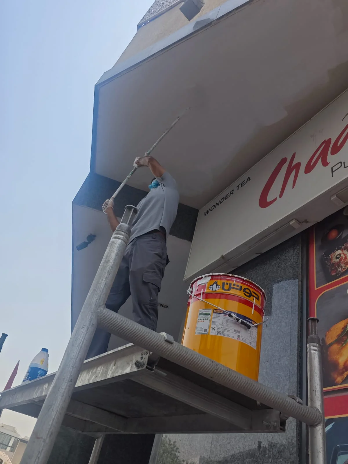 Technician painting an exterior wall at a Dubai property — supporting project view 1