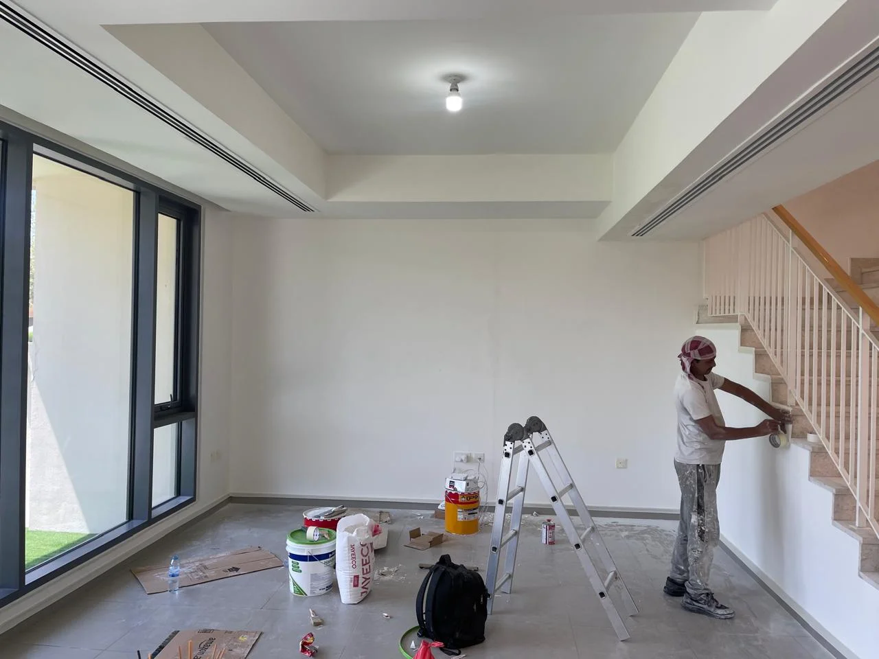 Painter working inside a villa living area in Dubai