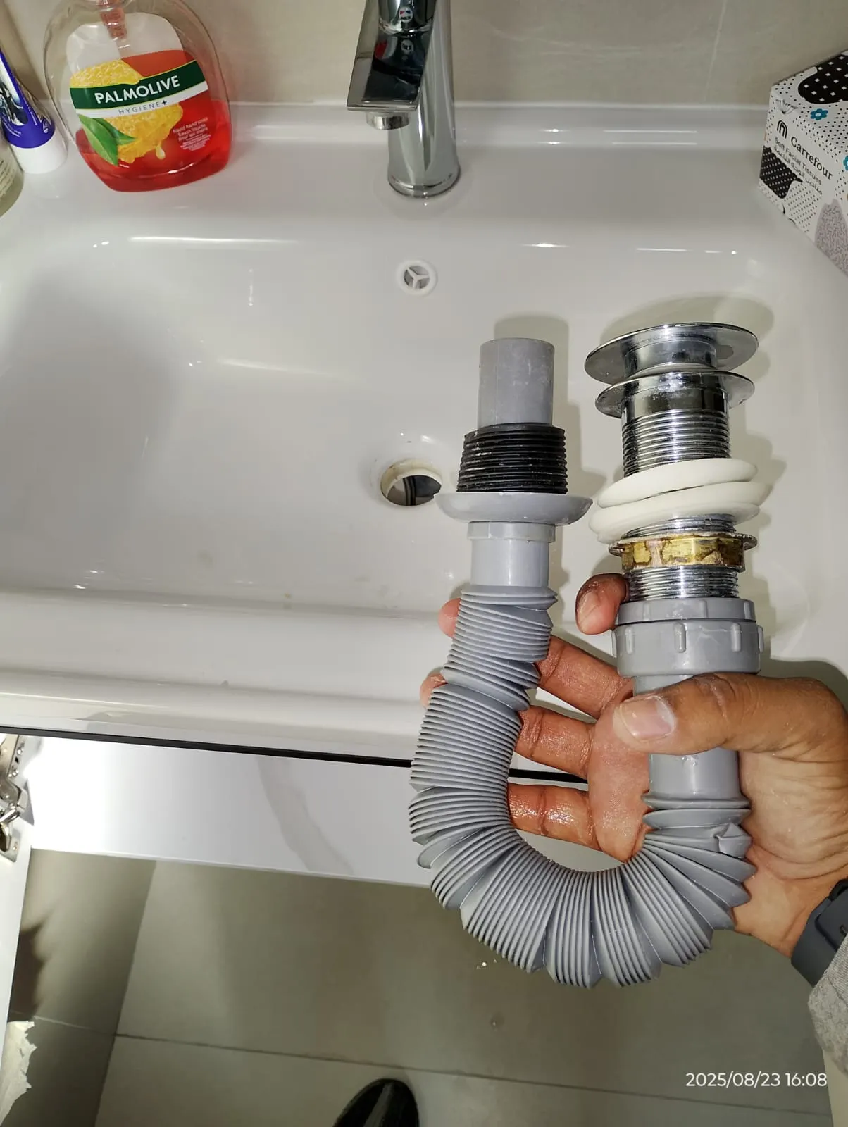 Technician repairing plumbing beneath a kitchen sink in Dubai — supporting project view 1