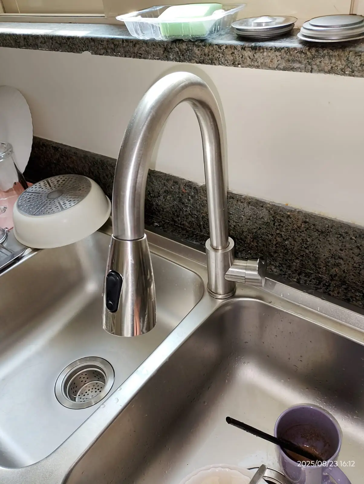 Technician repairing plumbing beneath a kitchen sink in Dubai — supporting project view 2