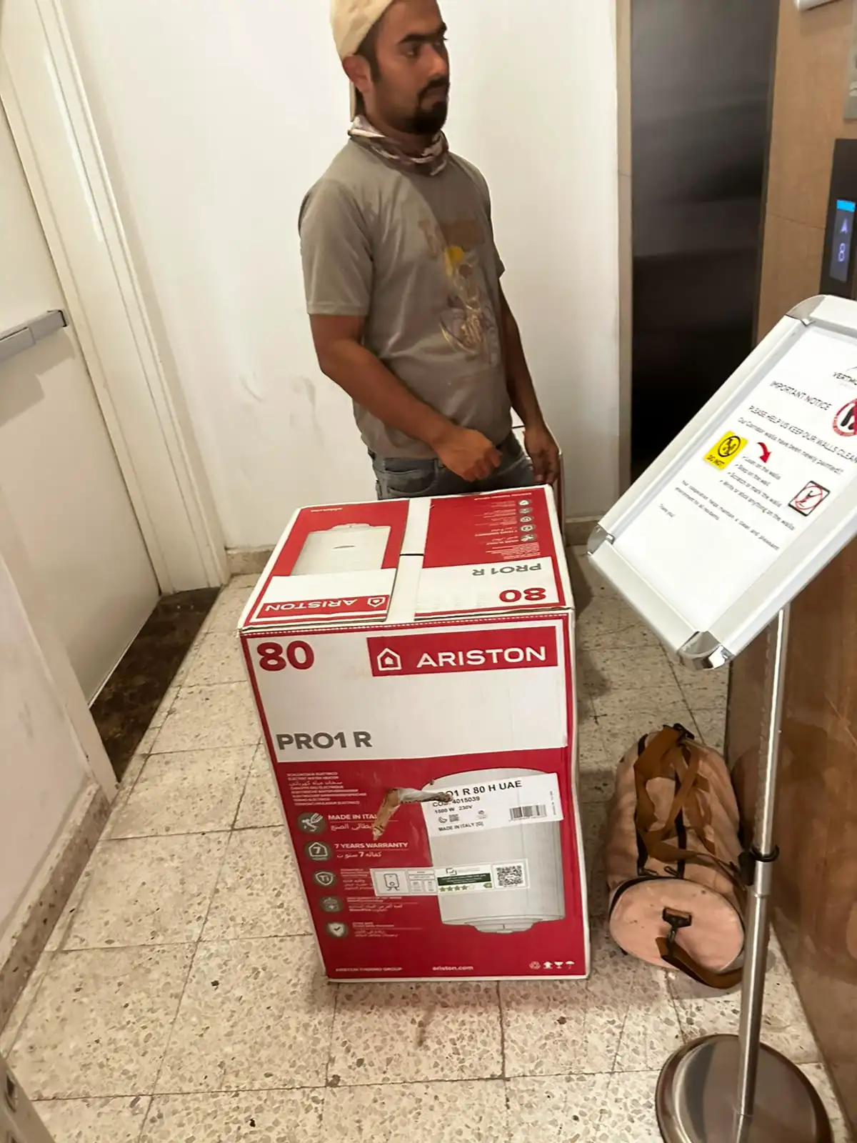 Technician repairing a water heater above a ceiling access panel in Dubai — supporting project view 3