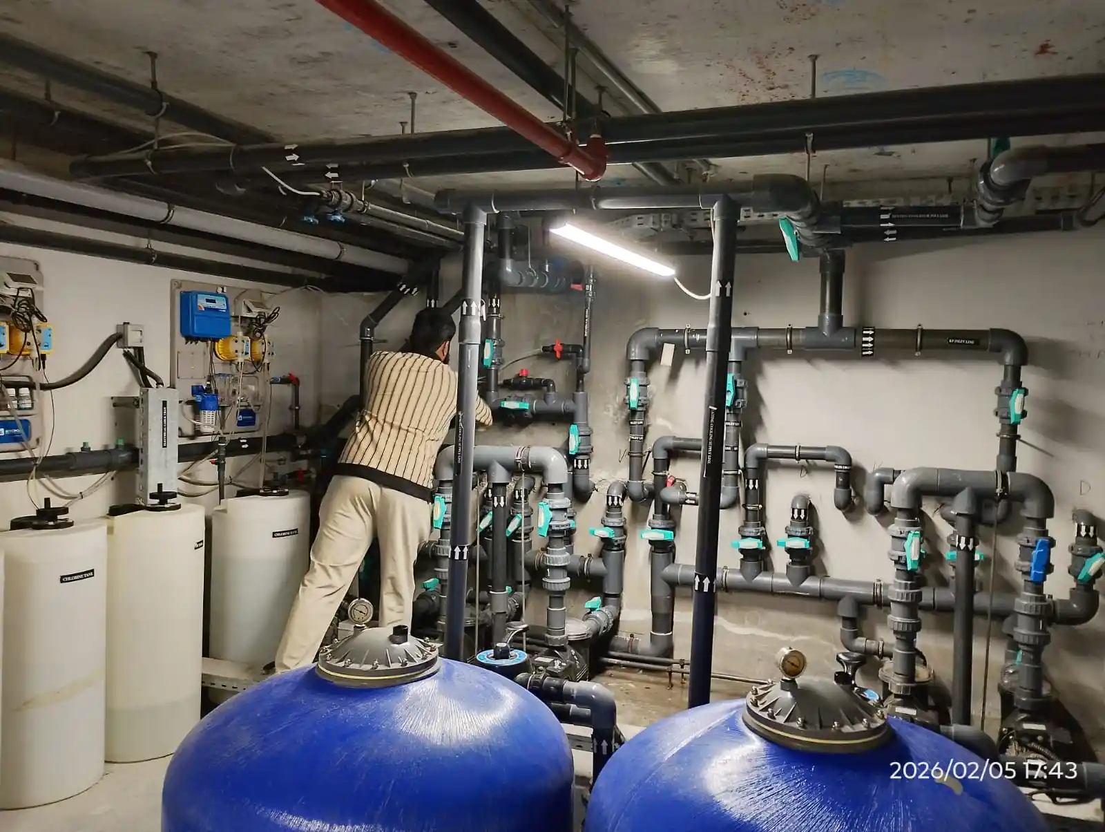 Technician cleaning an outdoor swimming pool in Dubai — supporting project view 2