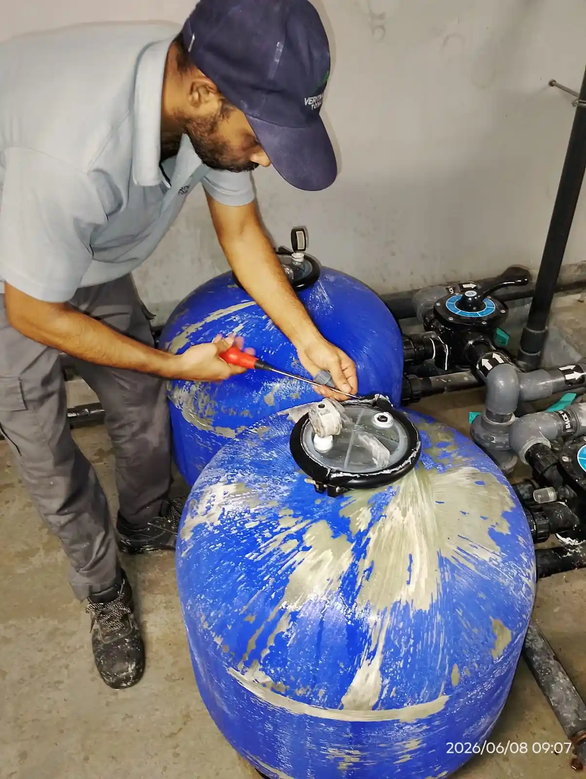 Technician checking pool pump and filtration equipment in Dubai — supporting project view 2