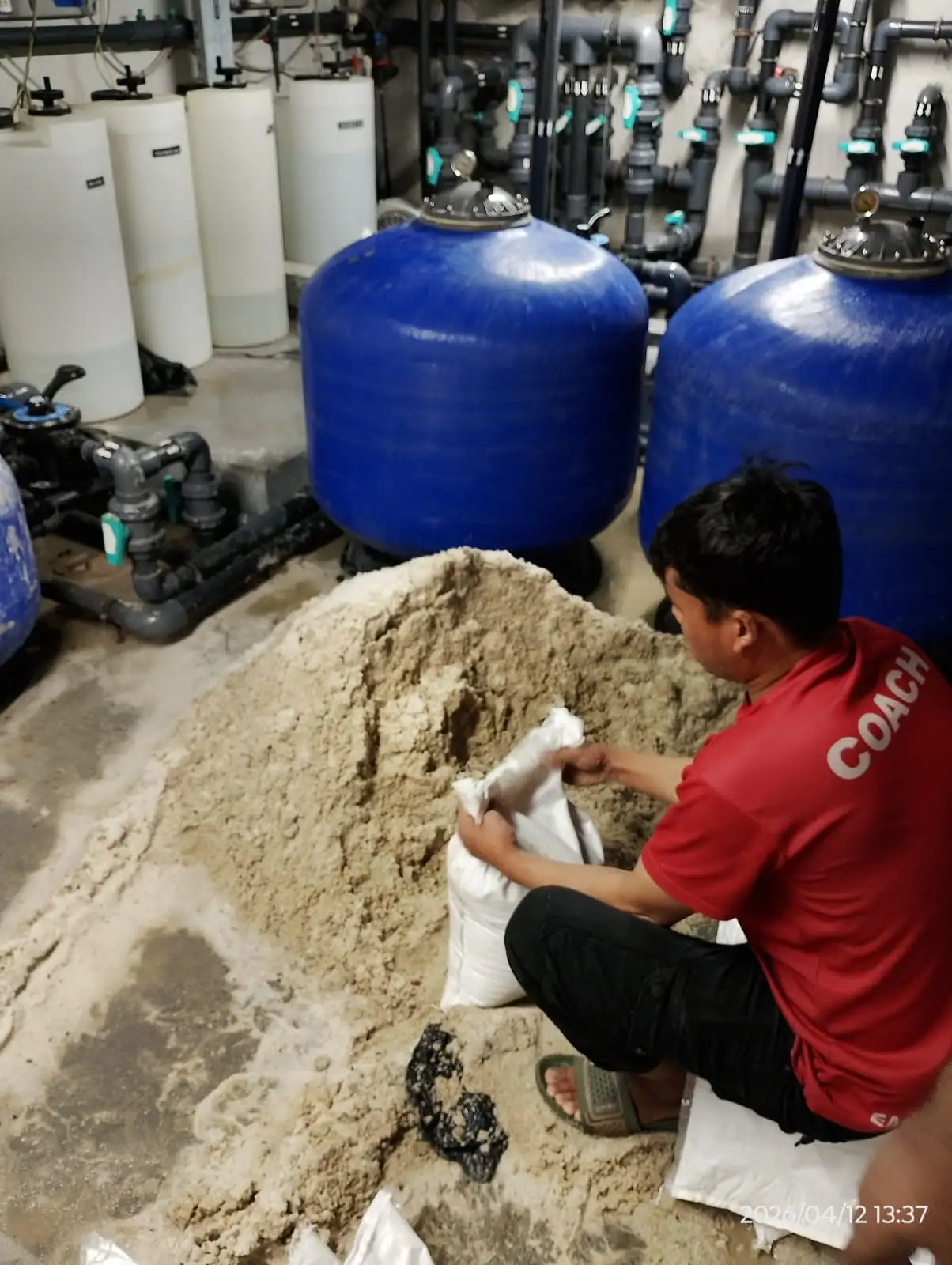 Technician checking pool pump and filtration equipment in Dubai — supporting project view 3